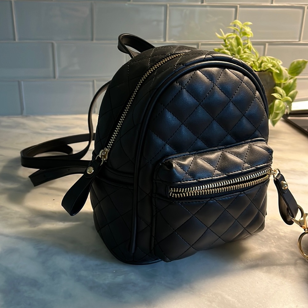 NEW black purse, backpack style with gold trim buckles and zippers. NWOT